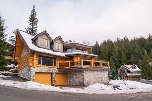 Snowridge Chalet ski-in/ski-out rental in Whistler surrounded by snow-covered mountains and evergreen trees