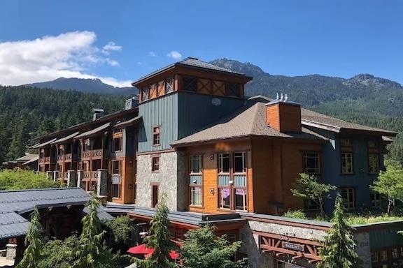Whistler Resort Club 306 condo building in Whistler Village with mountain scenery.