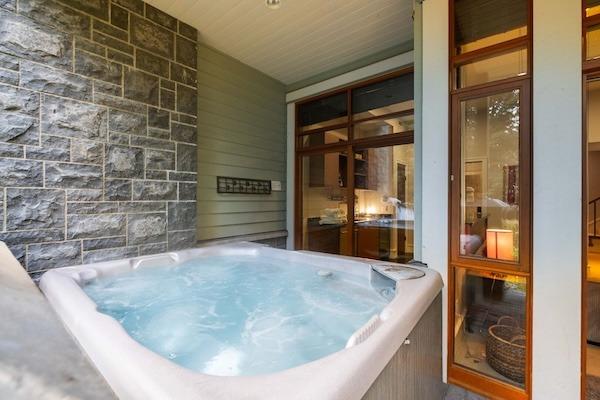 Private hot tub at a Whistler vacation rental with a covered outdoor patio